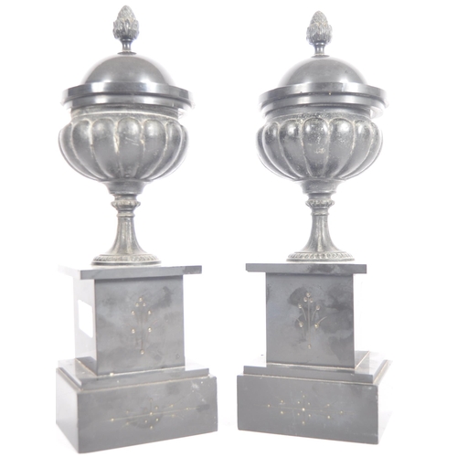 219 - A pair of 19th Century Grand Tour bronze classical lidded urns having acorn finial tops, reeded bodi... 