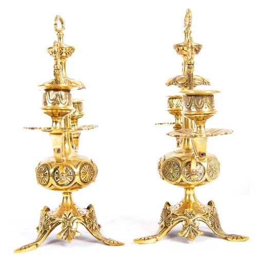 223 - A pair of 19th Century brass twin sconce candelabra having candlestick sconce raised on scrolled arm... 