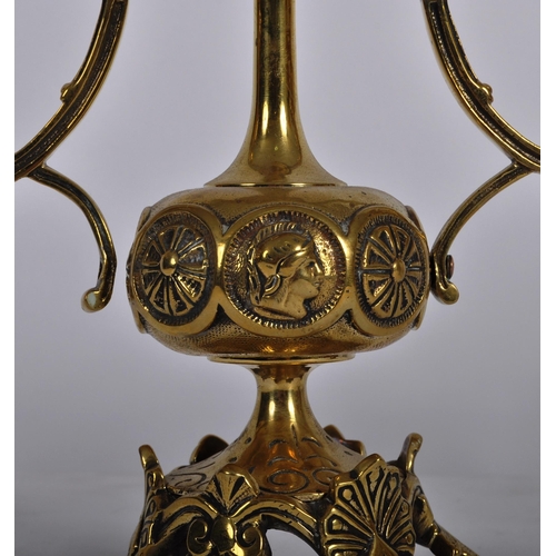 223 - A pair of 19th Century brass twin sconce candelabra having candlestick sconce raised on scrolled arm... 