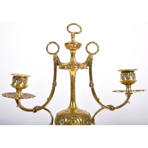 223 - A pair of 19th Century brass twin sconce candelabra having candlestick sconce raised on scrolled arm... 