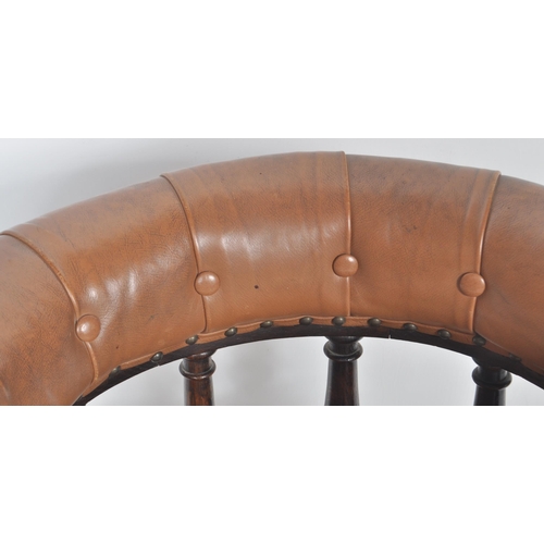 233 - An early 20th Century leather captains desk chair having a buttoned horseshoe backrest with leather ... 