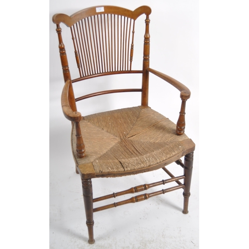 237 - A 19th Century Arts & Crafts armchair having a shaped top rail with central spindle backrest flanked... 