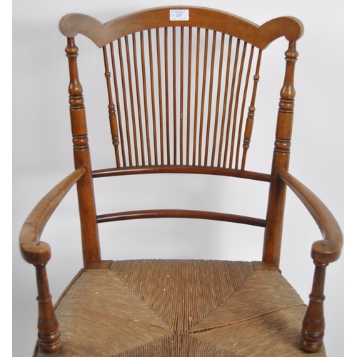 237 - A 19th Century Arts & Crafts armchair having a shaped top rail with central spindle backrest flanked... 