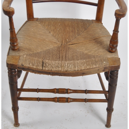 237 - A 19th Century Arts & Crafts armchair having a shaped top rail with central spindle backrest flanked... 