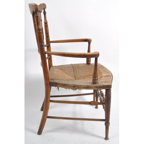 237 - A 19th Century Arts & Crafts armchair having a shaped top rail with central spindle backrest flanked... 