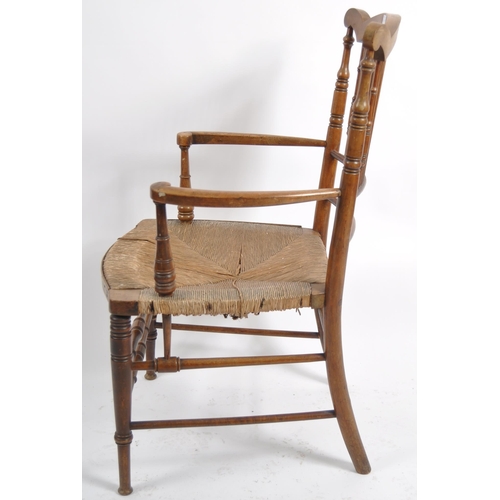 237 - A 19th Century Arts & Crafts armchair having a shaped top rail with central spindle backrest flanked... 