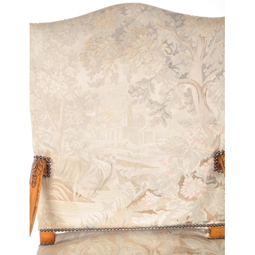 241 - A 19th Century French tapestry fauteuil armchair / throne chair having a padded back and seat rest w... 