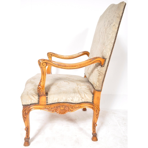 241 - A 19th Century French tapestry fauteuil armchair / throne chair having a padded back and seat rest w... 