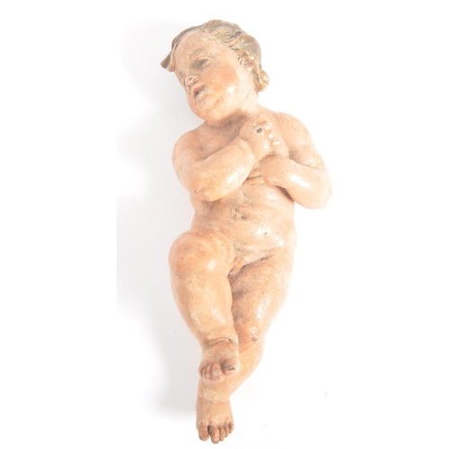 260 - An 18th Century Baroque polychrome cold painted wooden figure of a cherub. With fine facial expressi... 