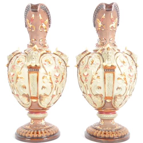 261 - A pair of 19th Century Wilhelm Schiller & Sohn German majolica ewer jugs of large size. Relief mould... 