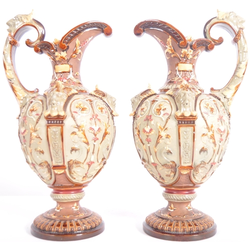 261 - A pair of 19th Century Wilhelm Schiller & Sohn German majolica ewer jugs of large size. Relief mould... 