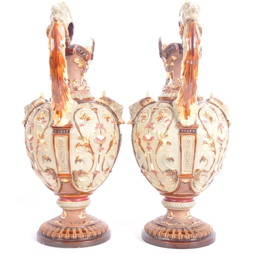 261 - A pair of 19th Century Wilhelm Schiller & Sohn German majolica ewer jugs of large size. Relief mould... 