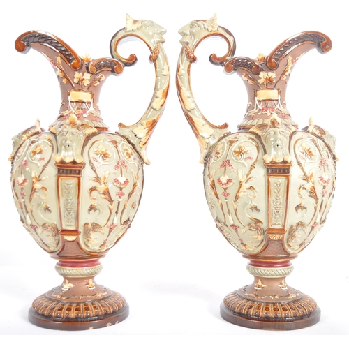 261 - A pair of 19th Century Wilhelm Schiller & Sohn German majolica ewer jugs of large size. Relief mould... 