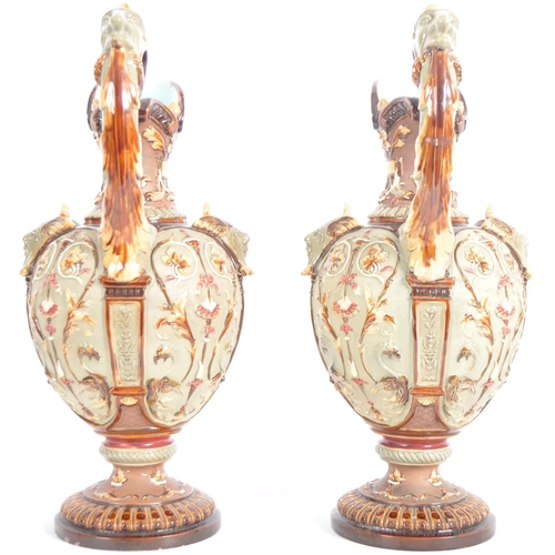 261 - A pair of 19th Century Wilhelm Schiller & Sohn German majolica ewer jugs of large size. Relief mould... 