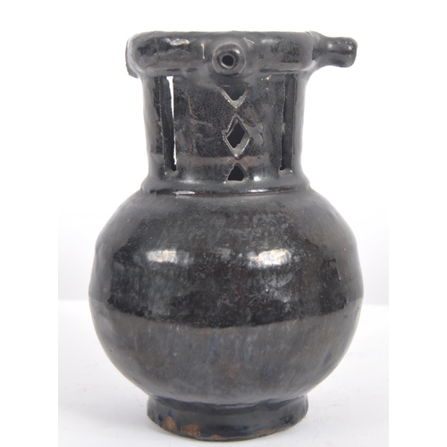 27 - An 18th Century Georgian pottery puzzle jug. Black painted finish with incised 1741 to globular body... 