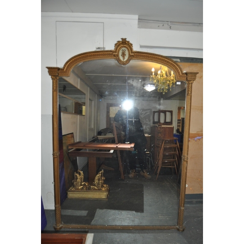 270 - A very large 19th Century overmantel wall mirror. Arched top with moulded details having a central w... 