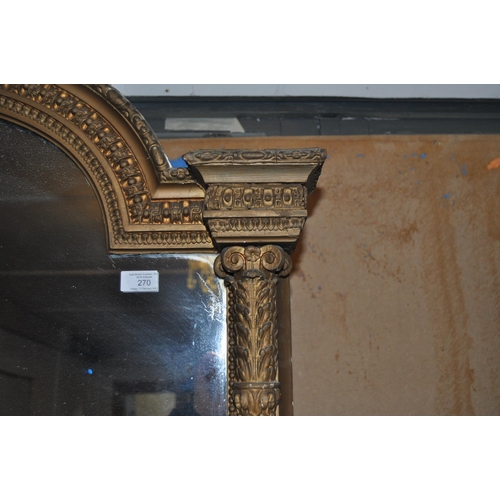 270 - A very large 19th Century overmantel wall mirror. Arched top with moulded details having a central w... 