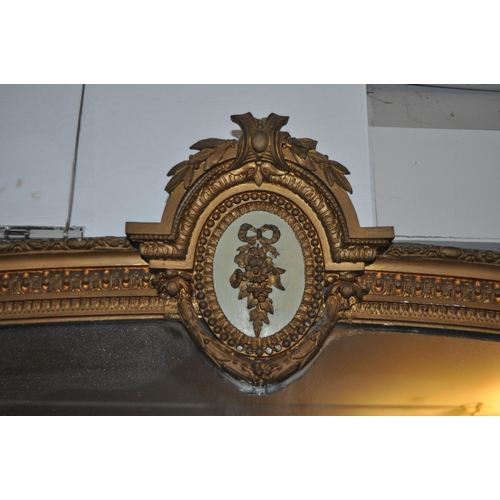 270 - A very large 19th Century overmantel wall mirror. Arched top with moulded details having a central w... 