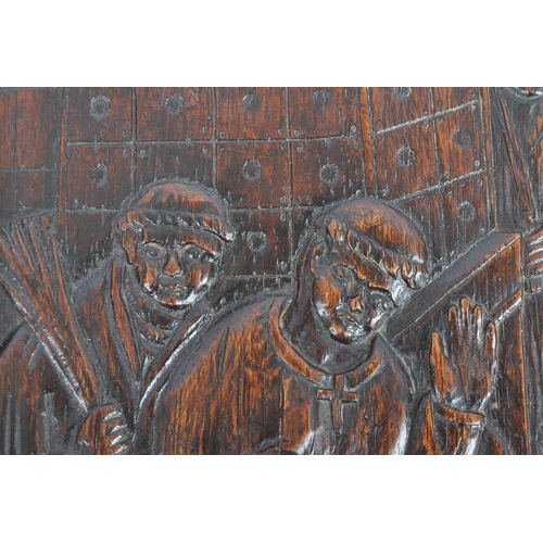 272 - A carved oak plaque depicting Henry II at the Tomb of Thomas Becket. The panel of rectangular form h... 