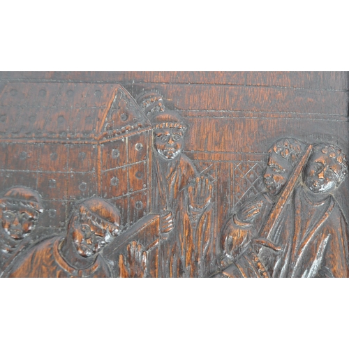 272 - A carved oak plaque depicting Henry II at the Tomb of Thomas Becket. The panel of rectangular form h... 