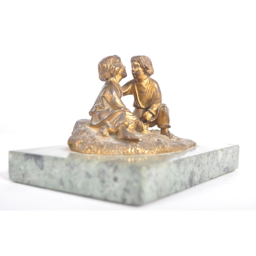 273 - A 19th Century gilt bronze figurine group depicting two boys playing a dice game. Set to a green mar... 