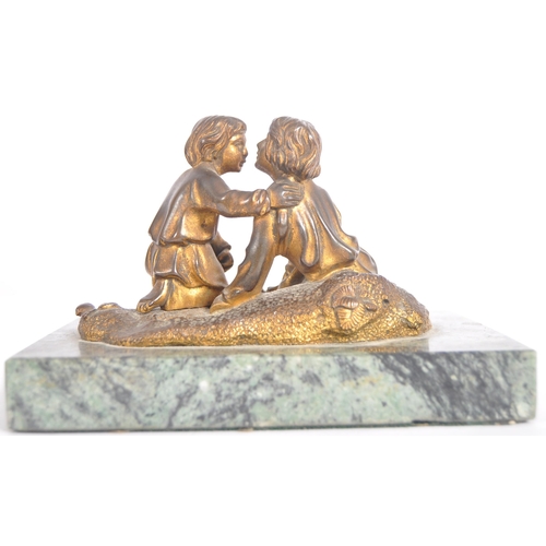 273 - A 19th Century gilt bronze figurine group depicting two boys playing a dice game. Set to a green mar... 