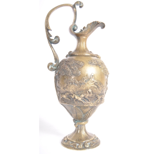 289 - A 19th Century Italian Grand Tour bronze ewer jug having relief cast hunting stag scenes with scroll... 