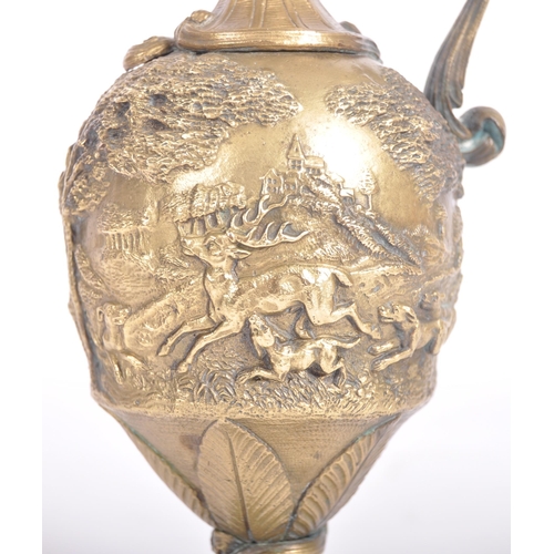 289 - A 19th Century Italian Grand Tour bronze ewer jug having relief cast hunting stag scenes with scroll... 