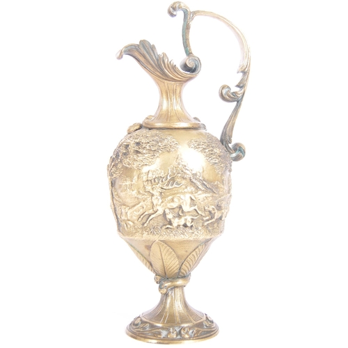 289 - A 19th Century Italian Grand Tour bronze ewer jug having relief cast hunting stag scenes with scroll... 