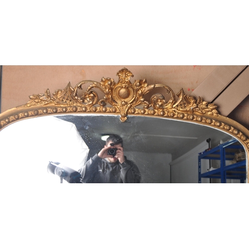 290 - A large 19th Century Victorian gilt wall mirror having a carved scrolled and floral pediment top wit... 