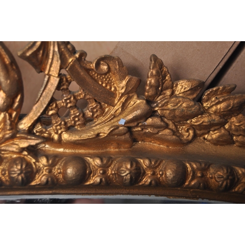 290 - A large 19th Century Victorian gilt wall mirror having a carved scrolled and floral pediment top wit... 