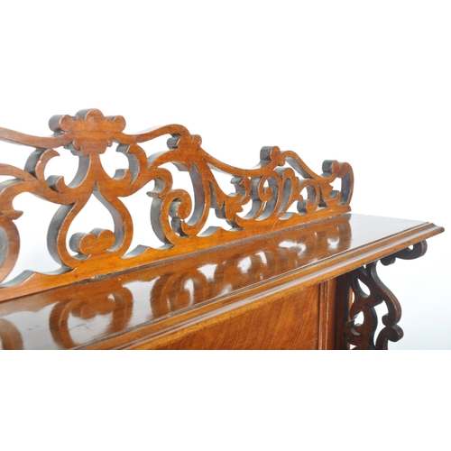 295 - A 19th Century Victorian mahogany open bookcase having a carved scrolled folate top with shelf below... 