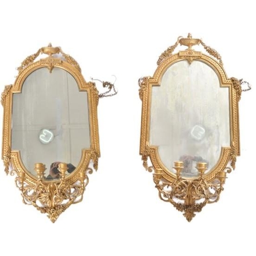 300 - A pair of 19th Century large gilt wood and gesso worked girandole wall mirrors. Each mirror adorned ... 