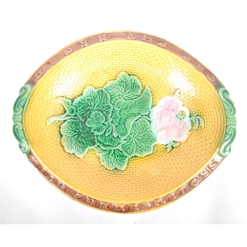 312 - A pair of 19th Century Majolica serving plates. A oval bread plate / basket with flower at the centr... 