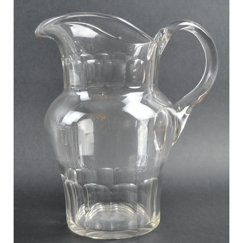 319 - A collection of 19th Century cut glassware to include a large pitcher jug, large conical bowl vase /... 