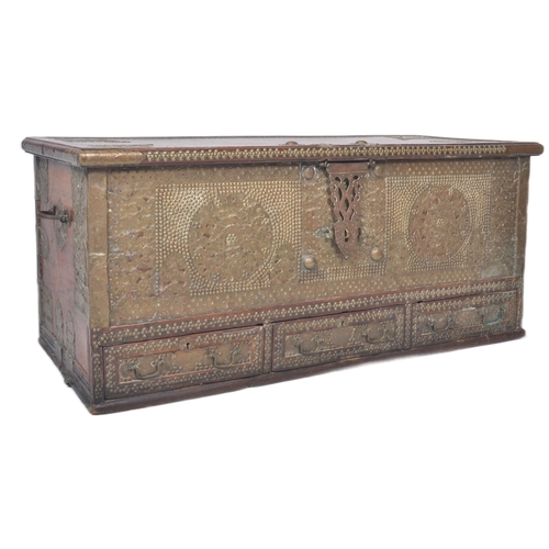 321 - A large 19th Century teak brass studded Zanzibar trunk. The front panel intricately decorated with b... 