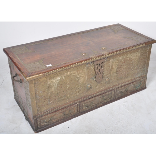 321 - A large 19th Century teak brass studded Zanzibar trunk. The front panel intricately decorated with b... 