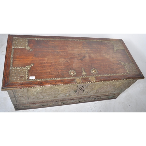 321 - A large 19th Century teak brass studded Zanzibar trunk. The front panel intricately decorated with b... 