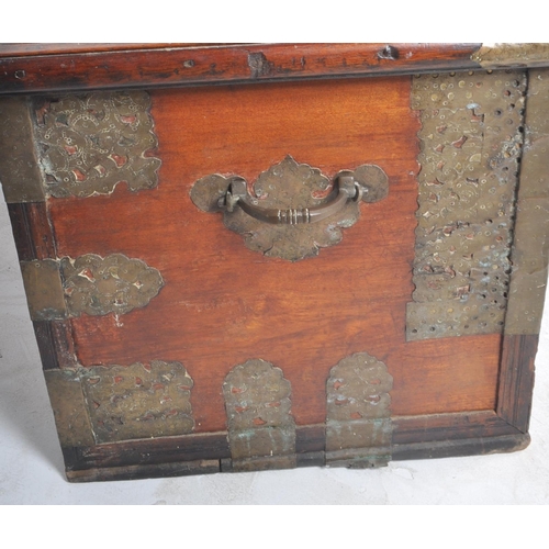 321 - A large 19th Century teak brass studded Zanzibar trunk. The front panel intricately decorated with b... 