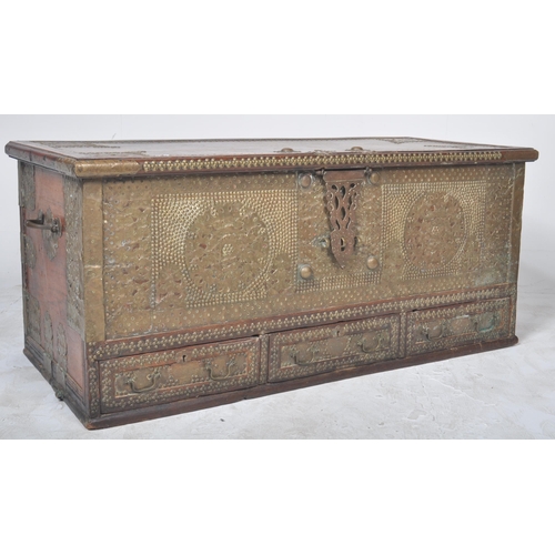 321 - A large 19th Century teak brass studded Zanzibar trunk. The front panel intricately decorated with b... 