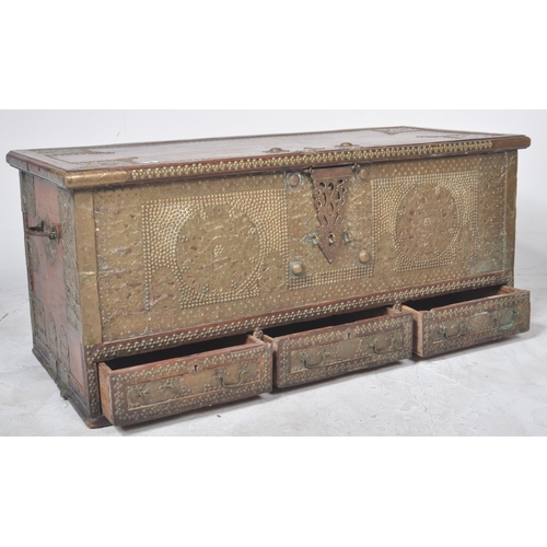 321 - A large 19th Century teak brass studded Zanzibar trunk. The front panel intricately decorated with b... 