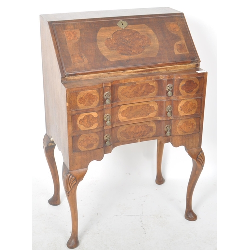 337 - An early 20th Century Queen Anne style walnut bureau desk having a fall front section top opening to... 