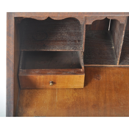 337 - An early 20th Century Queen Anne style walnut bureau desk having a fall front section top opening to... 