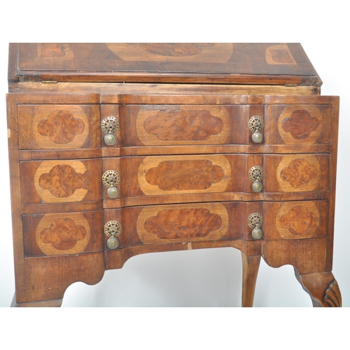 337 - An early 20th Century Queen Anne style walnut bureau desk having a fall front section top opening to... 