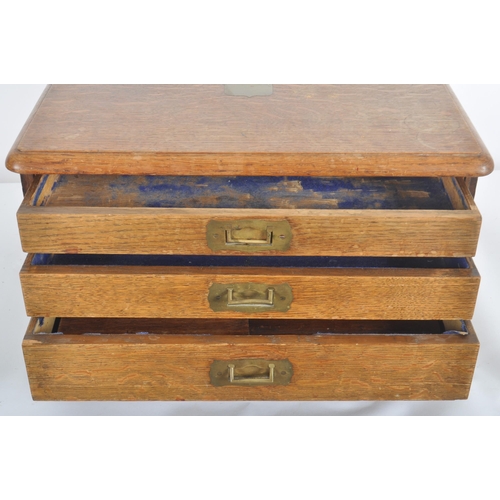 344 - A 19th century oak specimen / collectors campaign cabinet. A graduated three drawer cabinet with cam... 