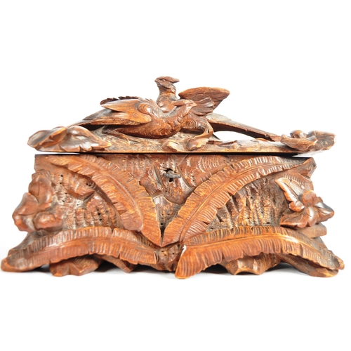 345 - An early 20th Century carved oak black forest lidded casket box having a brace of pheasants to top d... 