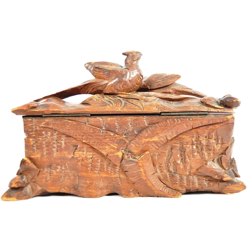 345 - An early 20th Century carved oak black forest lidded casket box having a brace of pheasants to top d... 