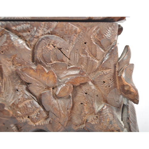 345 - An early 20th Century carved oak black forest lidded casket box having a brace of pheasants to top d... 