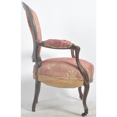 35 - A 19th Century Victorian rosewood salon armchair / chair. Shaped back with carved decoration. Pink f... 