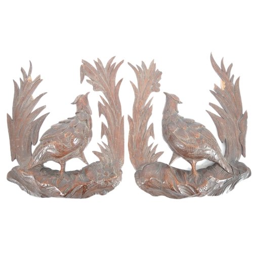 353 - A pair early 20th Century carved oak black forest wall plaques in the form of birds. Central pheasan... 